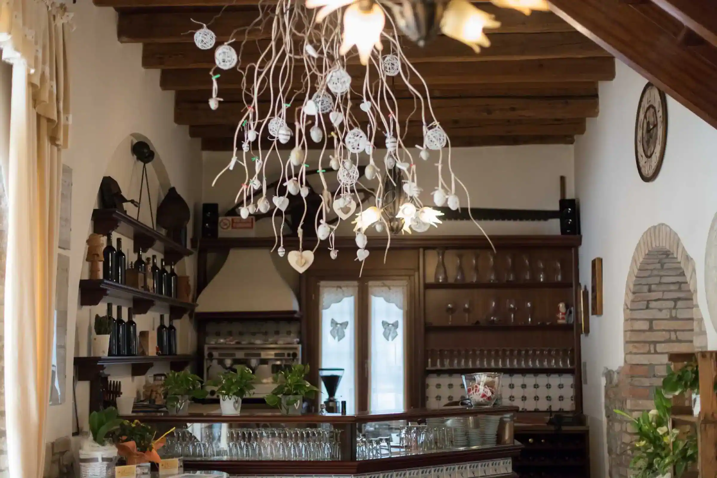The wooden bar with bottles, under exposed beams