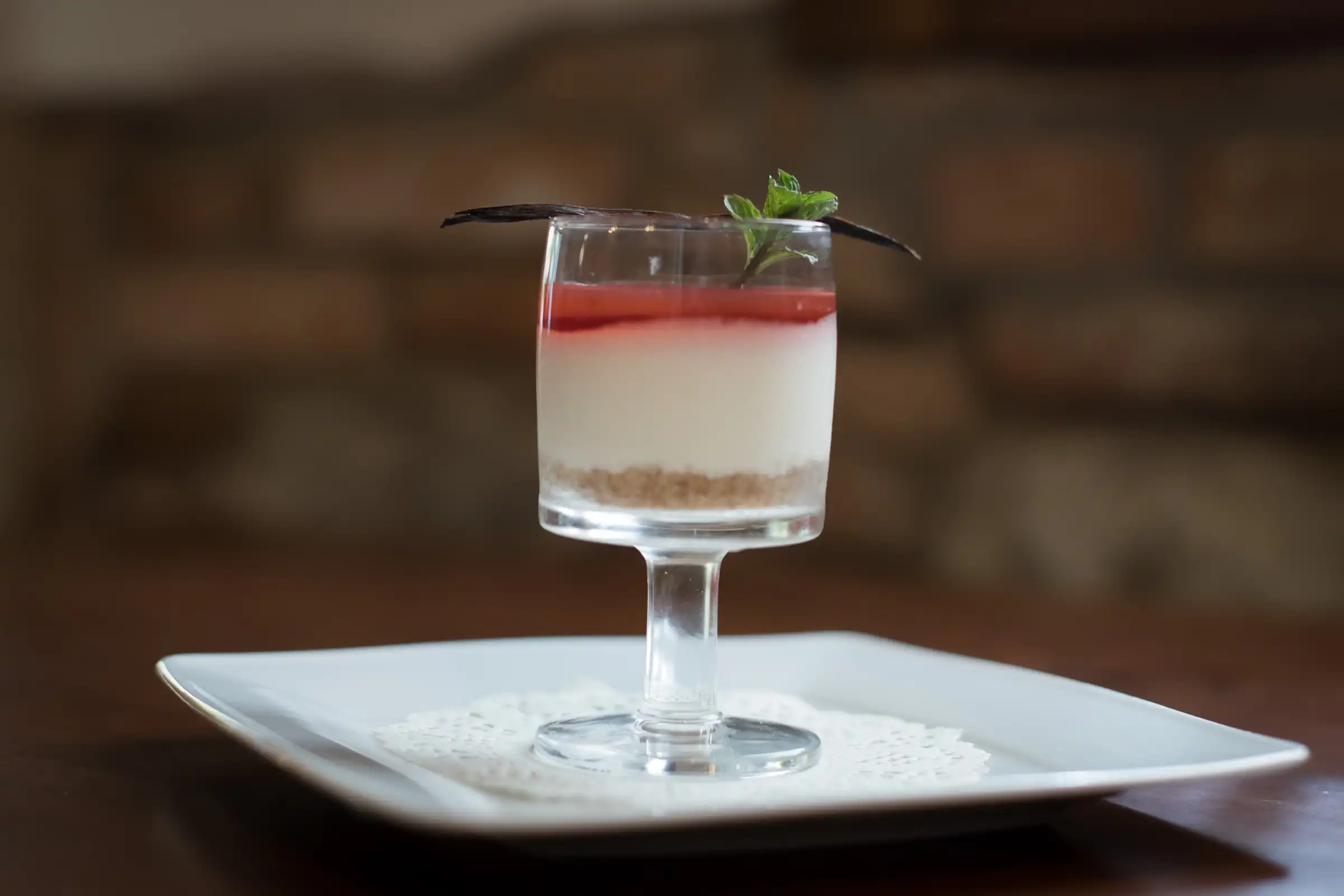 Dessert in a glass with cream and red-fruit jelly