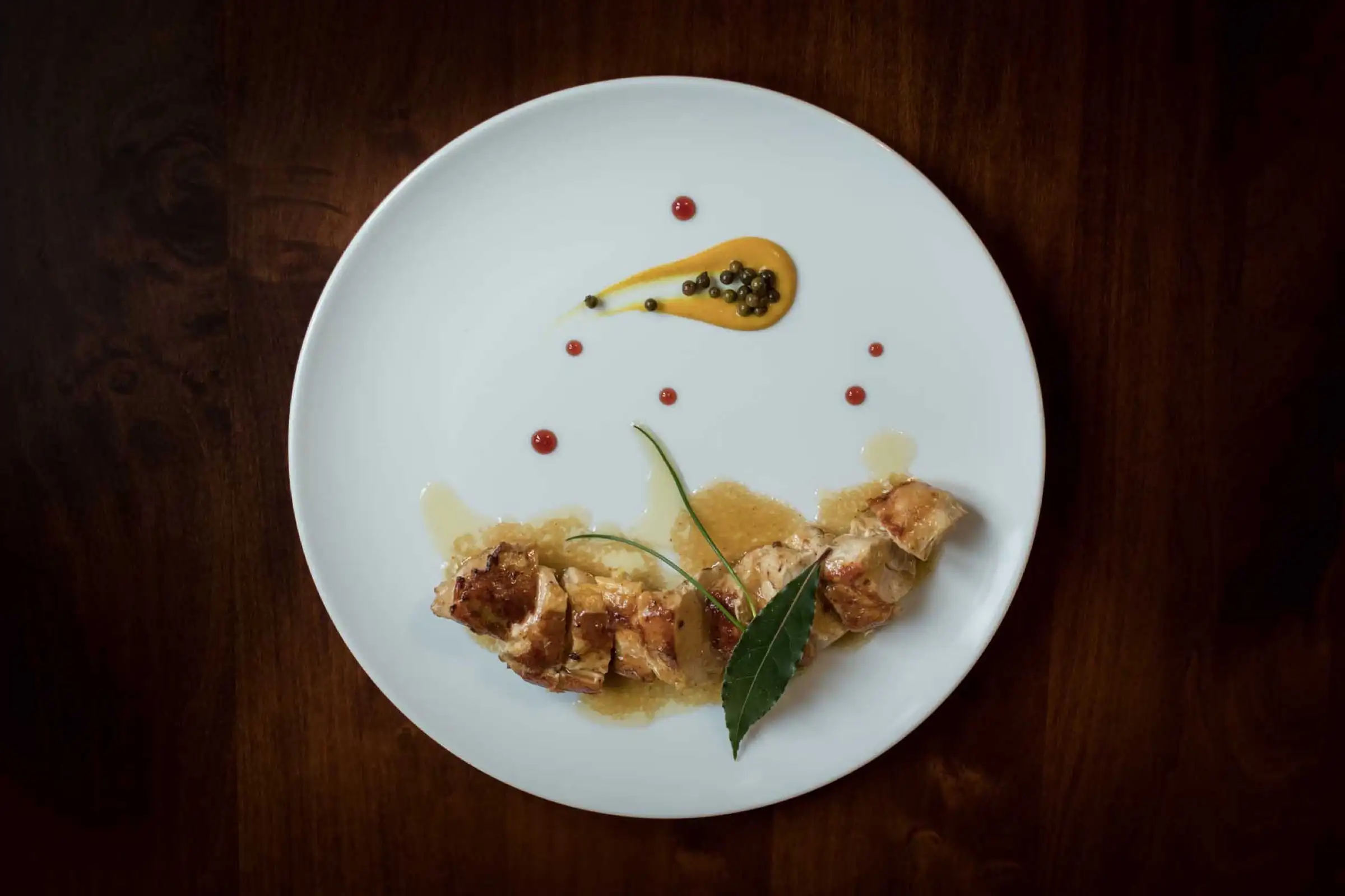 Rolled meat main course with a bay leaf and sauce